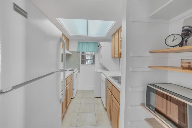 kitchen with white appliances, sink, light brown cabinets, and light tile patterned floors