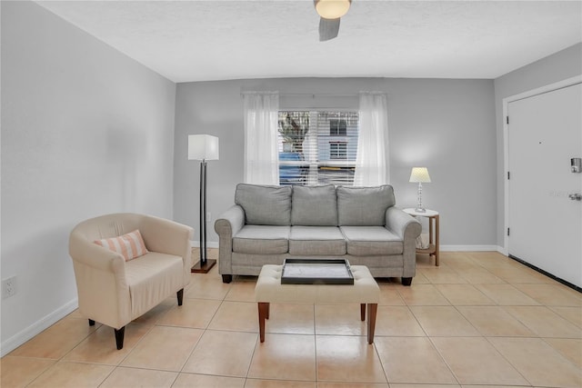 living room featuring a textured ceiling, ceiling fan, and light tile patterned flooring