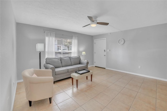 living room with light tile patterned floors, a textured ceiling, and ceiling fan