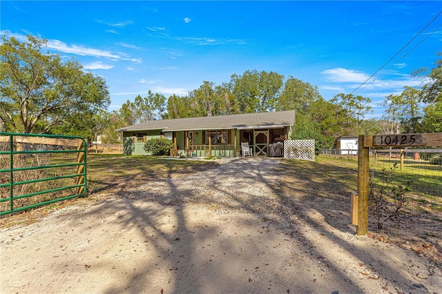 view of front of property with a porch and fence