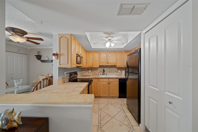 kitchen with ceiling fan, kitchen peninsula, light brown cabinets, and black appliances