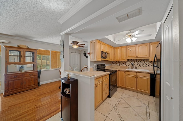 kitchen featuring light tile patterned flooring, sink, light brown cabinets, and black appliances