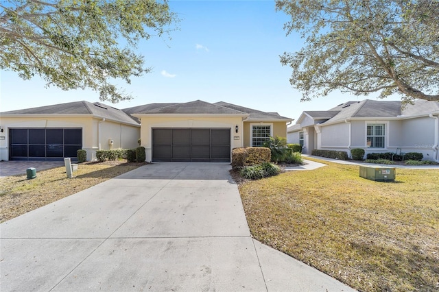 ranch-style home with a garage and a front lawn