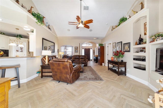 living room featuring ceiling fan, high vaulted ceiling, built in features, and light parquet floors