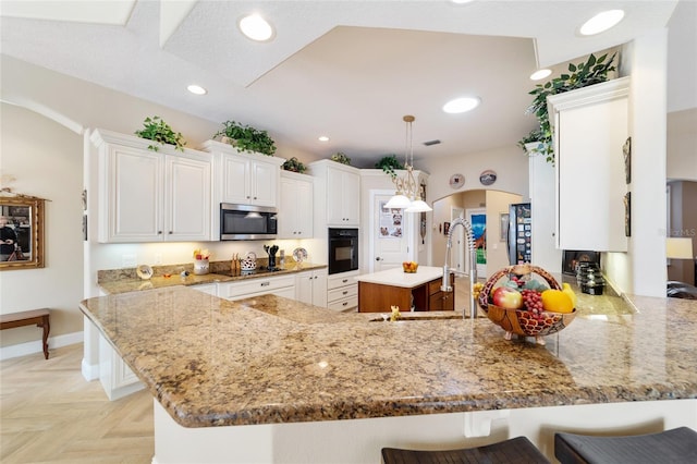 kitchen with a breakfast bar, sink, kitchen peninsula, black oven, and pendant lighting