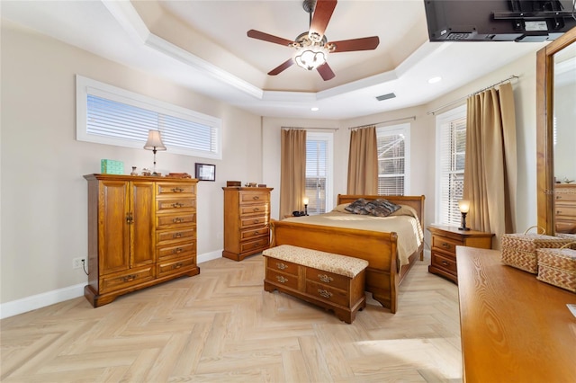 bedroom featuring a raised ceiling and light parquet floors