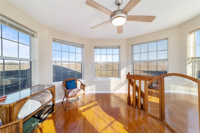 sunroom featuring ceiling fan