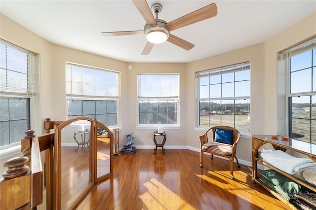 sunroom / solarium with a wealth of natural light and ceiling fan