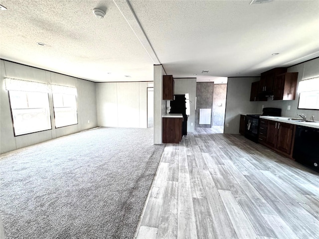 kitchen featuring black appliances, sink, light hardwood / wood-style floors, dark brown cabinetry, and a textured ceiling