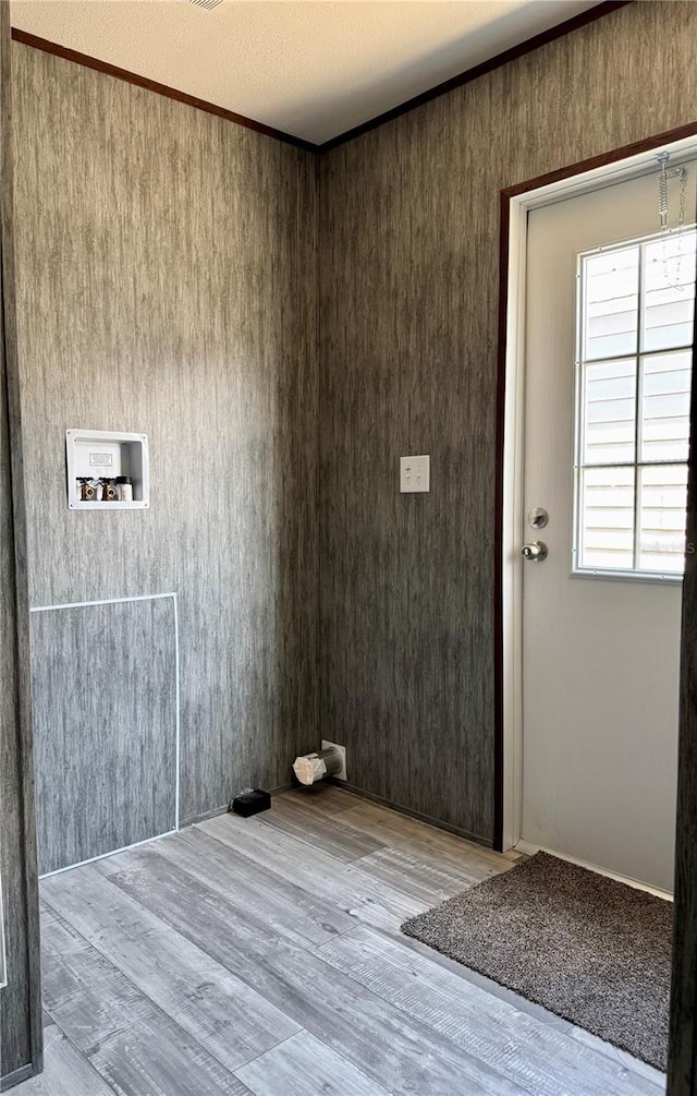 interior space with crown molding and light wood-type flooring