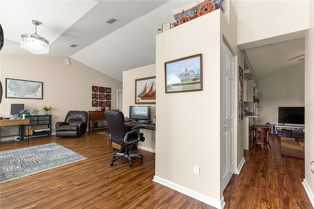 office with lofted ceiling, a notable chandelier, and dark hardwood / wood-style flooring