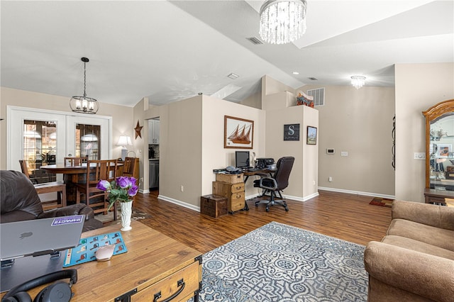 office space with wood-type flooring, vaulted ceiling, and a notable chandelier