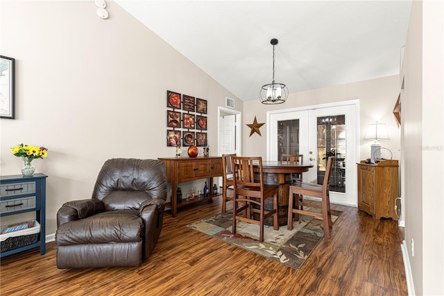 dining space with dark hardwood / wood-style flooring, a notable chandelier, vaulted ceiling, and french doors