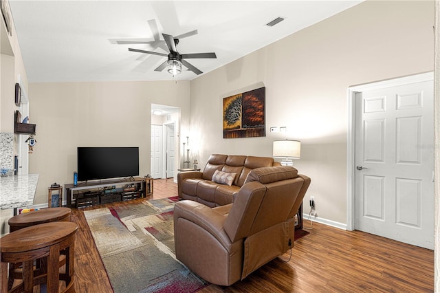 living room featuring hardwood / wood-style floors, vaulted ceiling, and ceiling fan