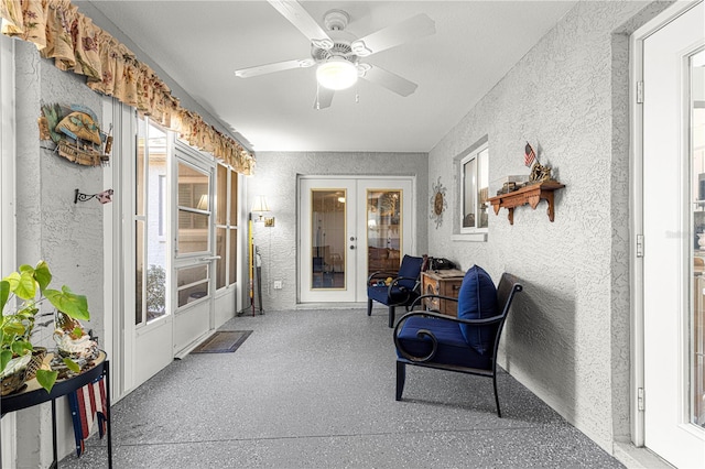 sunroom / solarium with french doors and ceiling fan