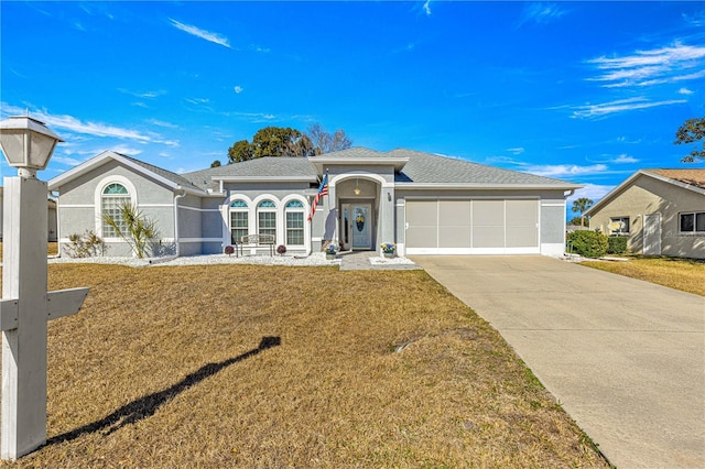 ranch-style home featuring a garage and a front yard