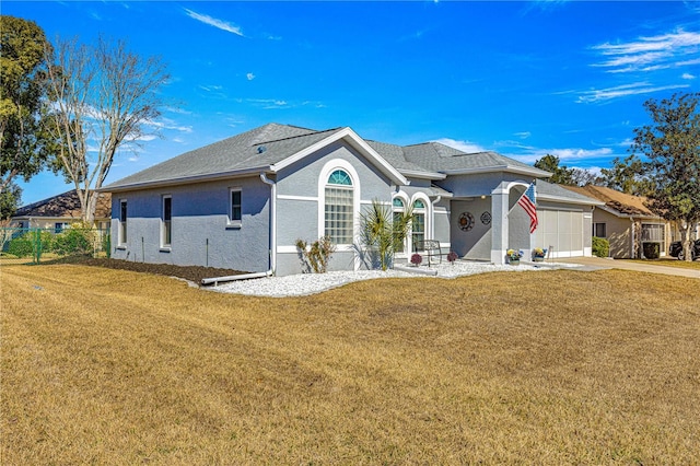 view of front facade with a garage and a front lawn