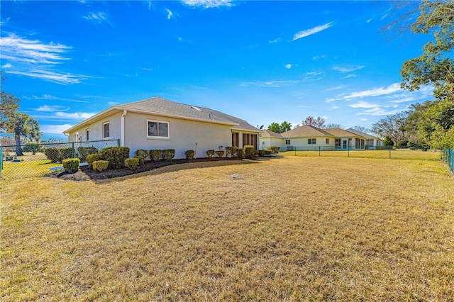 rear view of house featuring a lawn