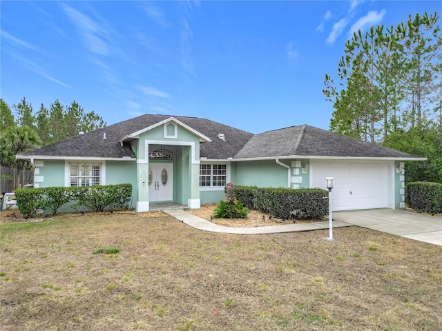 ranch-style house with a garage and a front yard