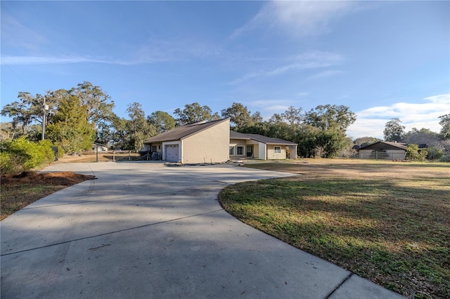 view of side of home featuring a garage and a yard