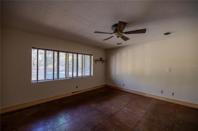 spare room featuring ceiling fan and a textured ceiling