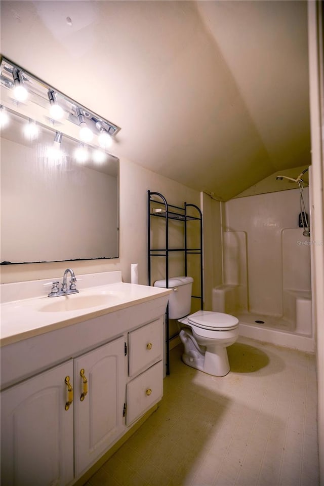 bathroom with lofted ceiling, vanity, toilet, and a shower