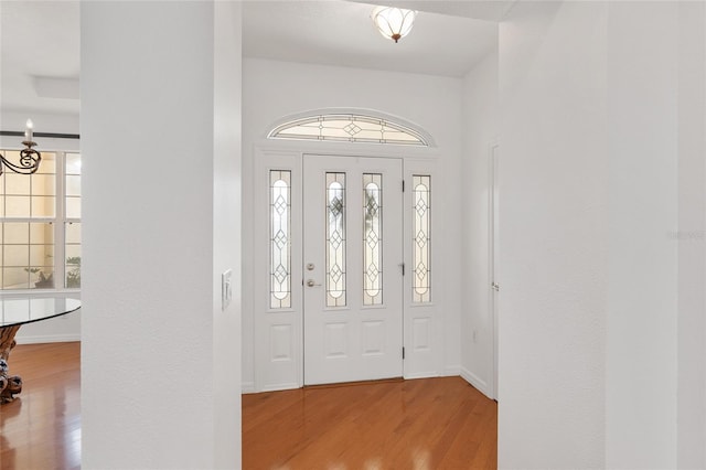 foyer featuring an inviting chandelier and light hardwood / wood-style flooring