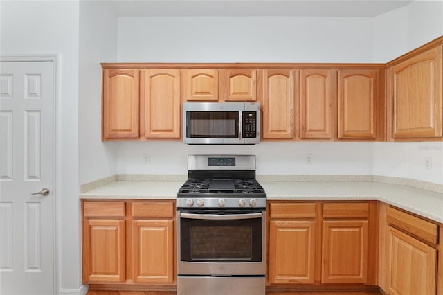 kitchen featuring appliances with stainless steel finishes and light brown cabinets