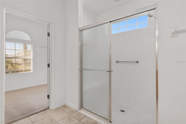 bathroom featuring walk in shower and tile patterned floors