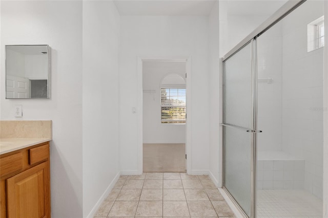 bathroom featuring walk in shower, tile patterned floors, and vanity