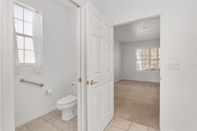 bathroom featuring tile patterned flooring and toilet