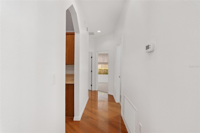 hallway with light hardwood / wood-style floors