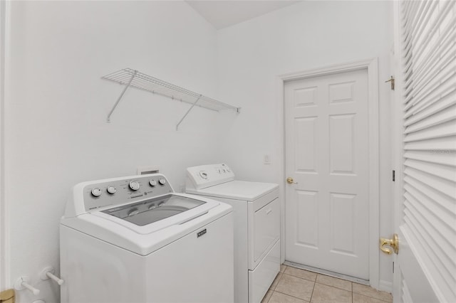 laundry room featuring light tile patterned floors and washing machine and dryer