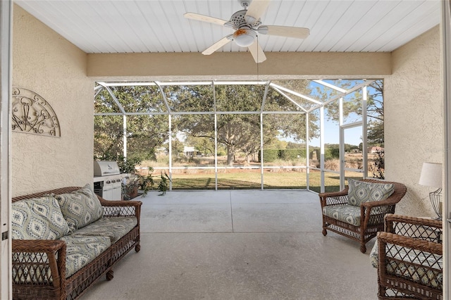 view of patio / terrace featuring ceiling fan, a grill, and glass enclosure