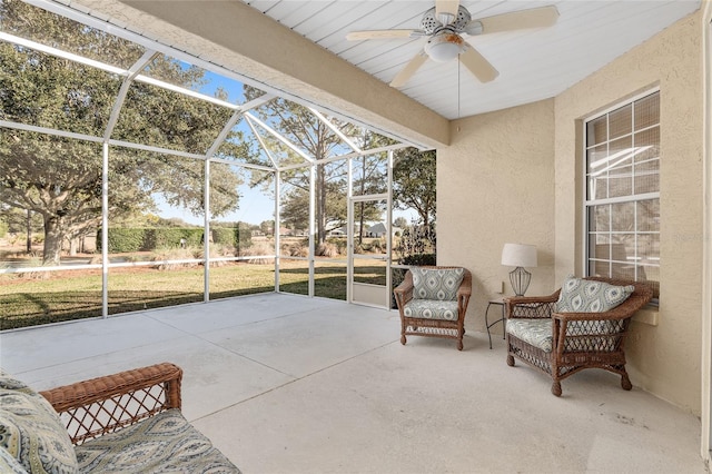 view of patio / terrace featuring ceiling fan and glass enclosure