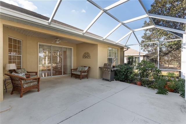 view of patio / terrace with ceiling fan, an outdoor hangout area, area for grilling, and glass enclosure