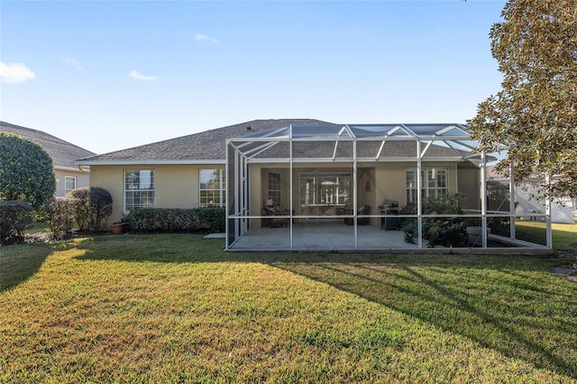 back of house featuring a yard, a lanai, and a patio