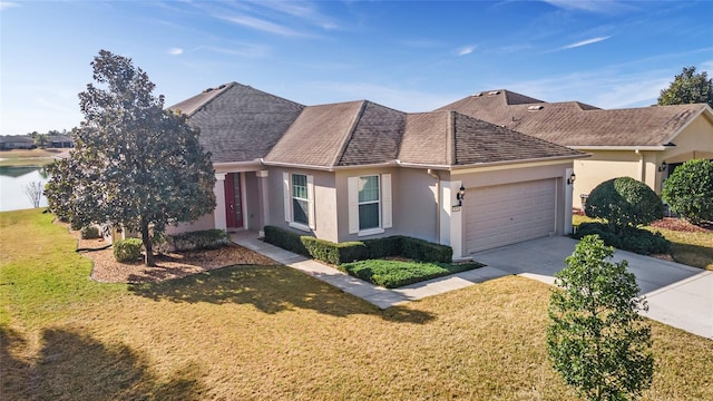 view of front of house with a water view, a garage, and a front yard