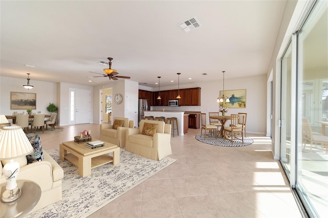 living room featuring ceiling fan and light tile patterned floors