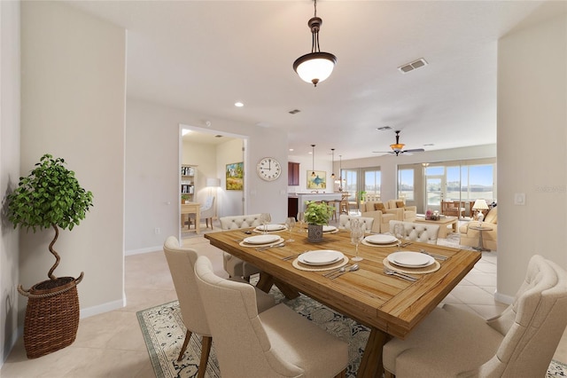 tiled dining room featuring ceiling fan