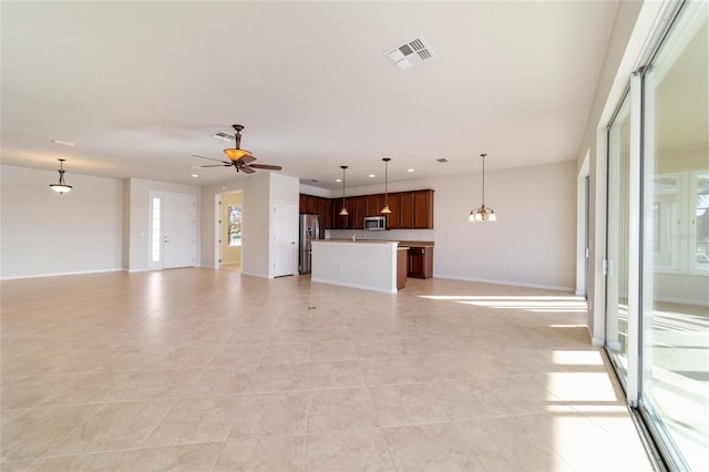 unfurnished living room with ceiling fan