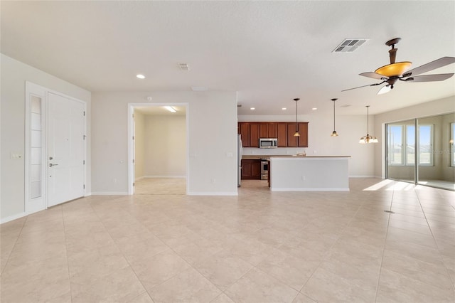 unfurnished living room featuring ceiling fan and light tile patterned floors