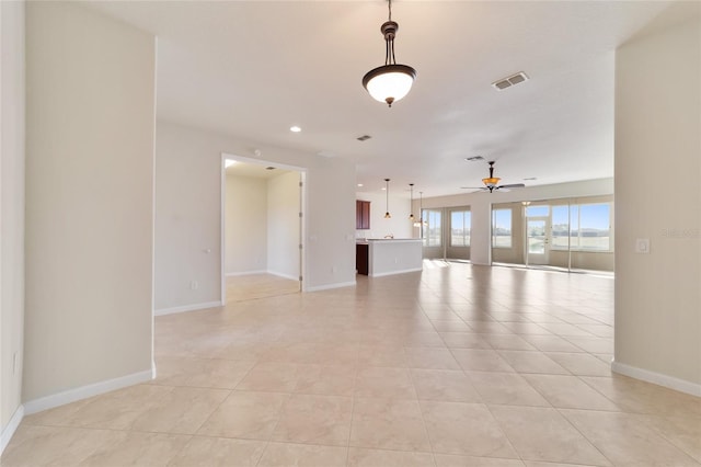 tiled empty room with ceiling fan