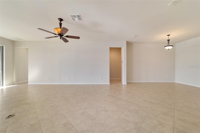 tiled spare room featuring ceiling fan