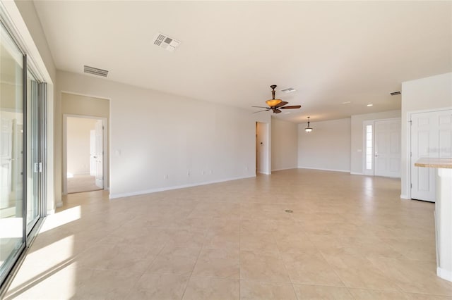 empty room featuring ceiling fan and light tile patterned floors