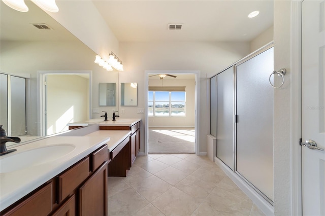 bathroom featuring vanity, an enclosed shower, and tile patterned floors