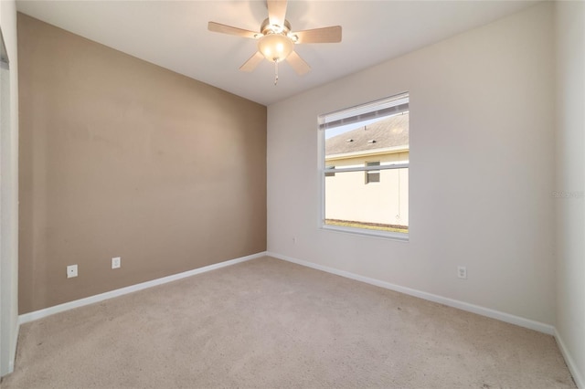 carpeted empty room featuring ceiling fan