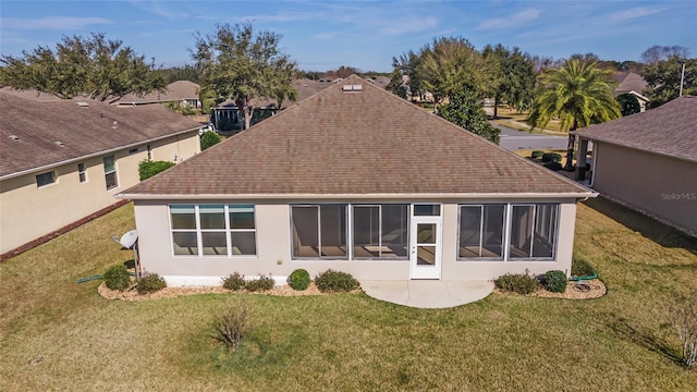 rear view of house with a yard and a patio