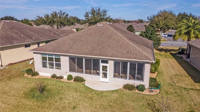 rear view of house featuring a yard