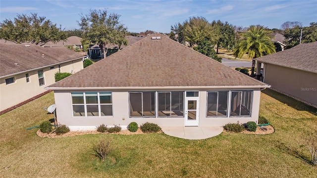 back of property with a yard and a patio area